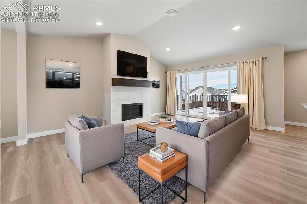 Virtually staged living room with fireplace and walk-out! 