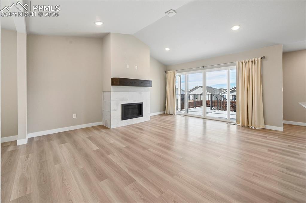 Unstaged living room with fireplace and walk-out!