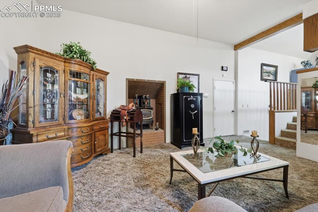 Lower level family room has a free standing wood stove, door to the garage, stairs up to the kitchen and stairs down to the basement.