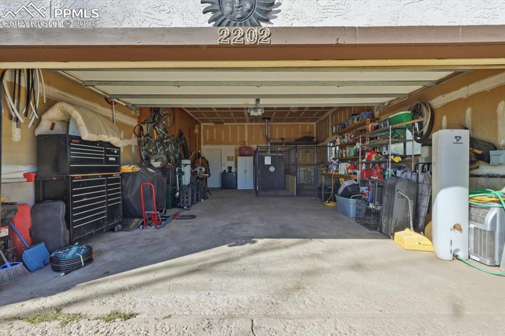 Attached 2 car garage has a door that leads to the family room and another door that leads to the front porch