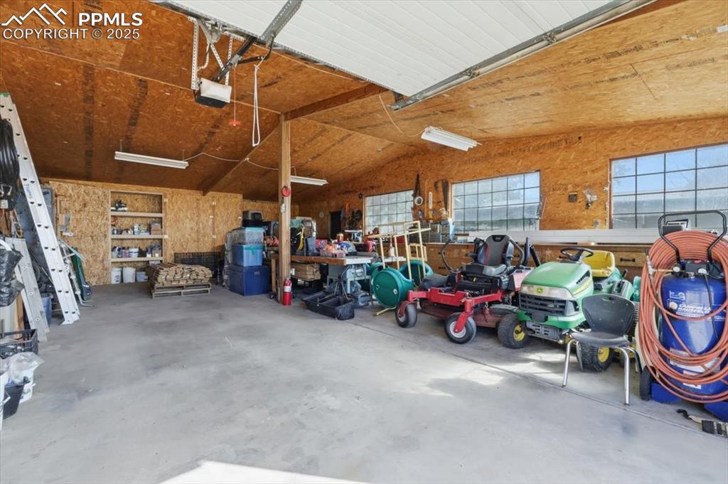 Workshop could house additional vehicles for the car enthusiast. There are built in cabinets along the back wall, and a cabinet with multiple drawers for all your workshop tools. There is also an attached 10x10 room for extra storage.