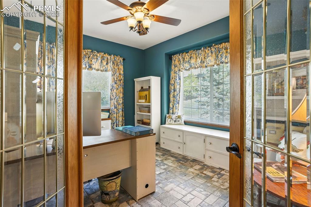 Rustic brick tile floor and windows add bright character to this front office