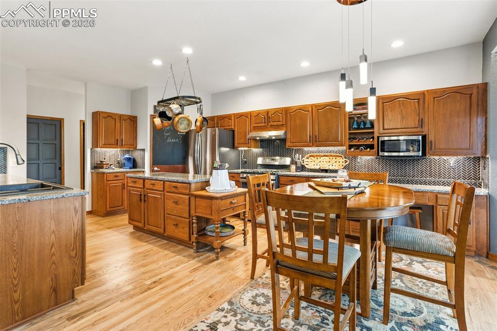 Walk-in pantry, warm wood tones in cupboards and flooring make this space welcoming.  