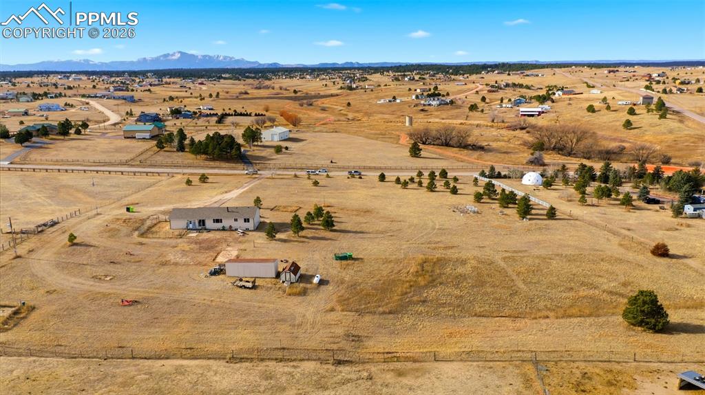 Overview of rural landscape with a desert landscape and a mountain backdrop
