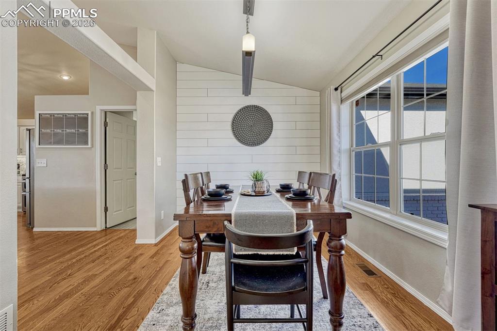 With its pitched ceiling and open connection to the kitchen, this room feels larger than its footprint, while bright east-facing light fills the space and flows into the main living areas