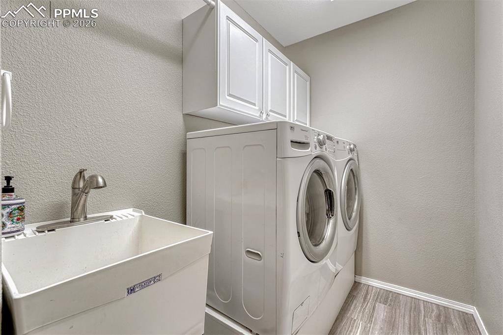 In the main level laundry, you'll find a mud sink and overhead storage. From here, step out to the 3 car heated garage with built in storage, extra room for a workshop and a side door for quick access to the side yard