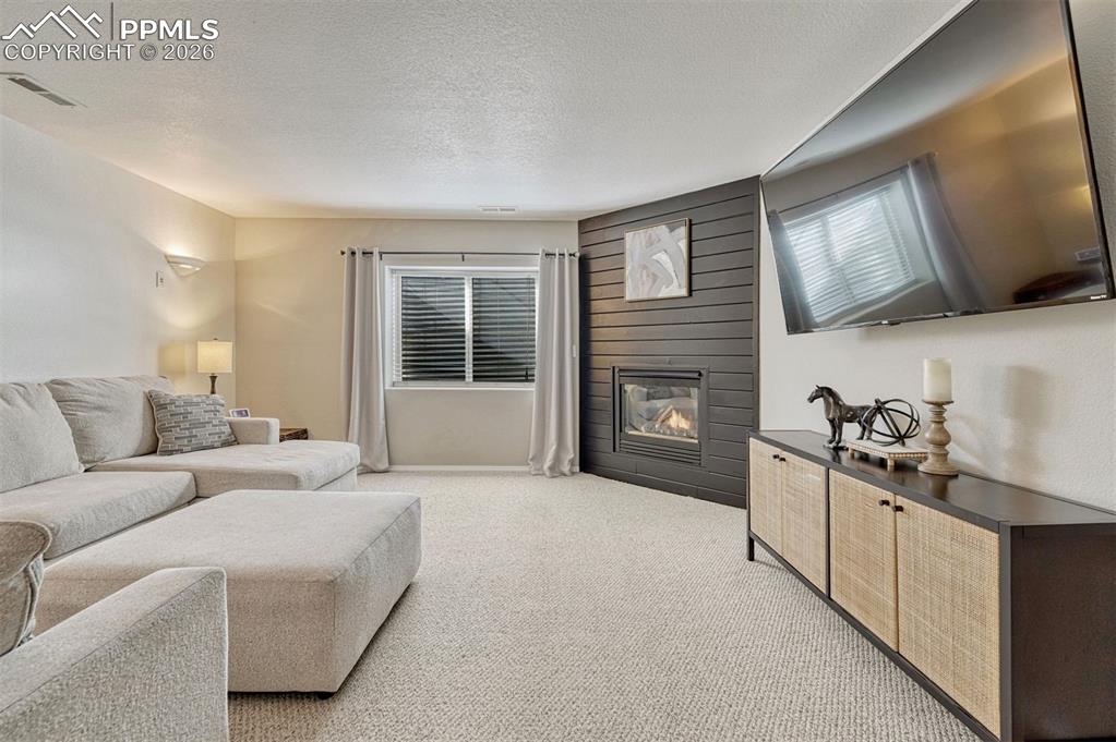 The recreation room is ready for movie nights, game days, or cozy gatherings by the gas fireplace with its sleek surround