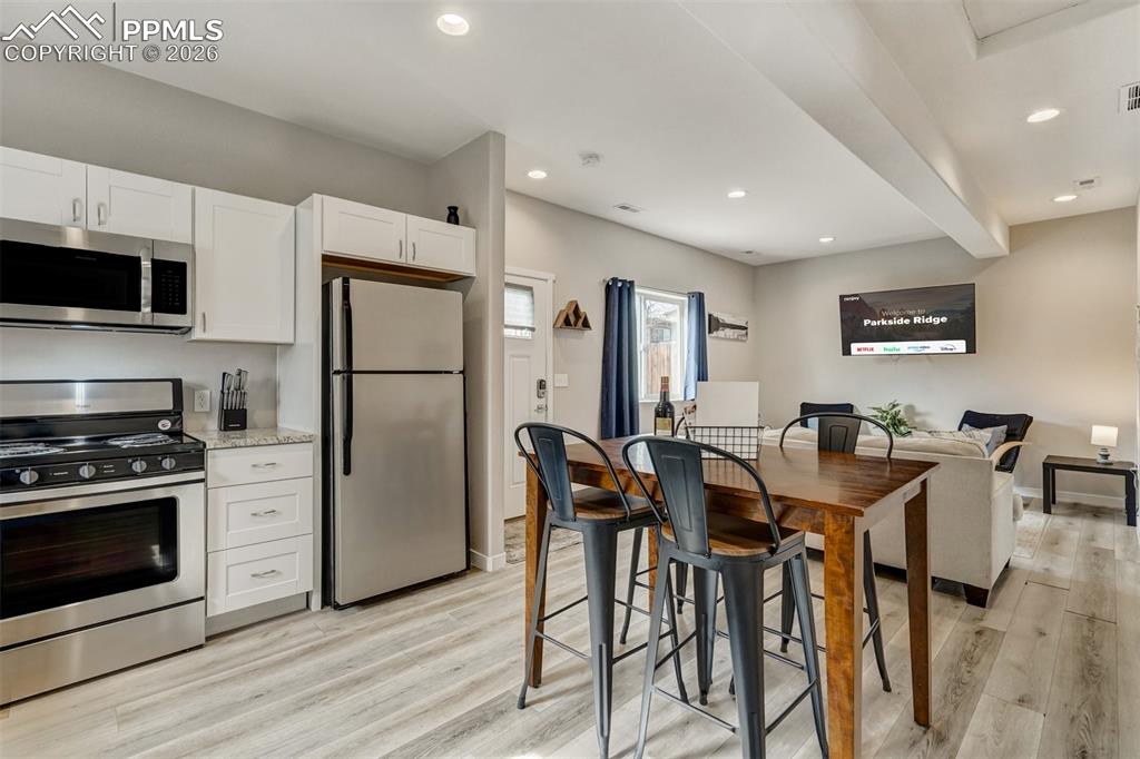 Cottage kitchen and view of dining and living area
