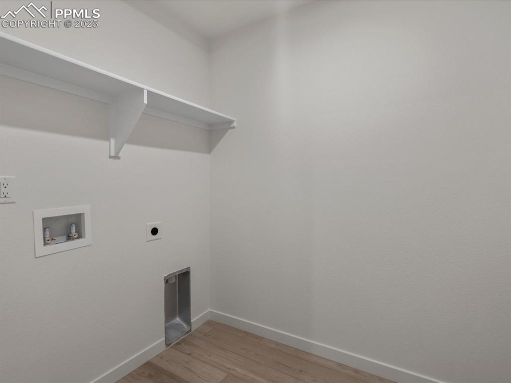 Washroom featuring hookup for a washing machine, hookup for an electric dryer, and light wood-type flooring