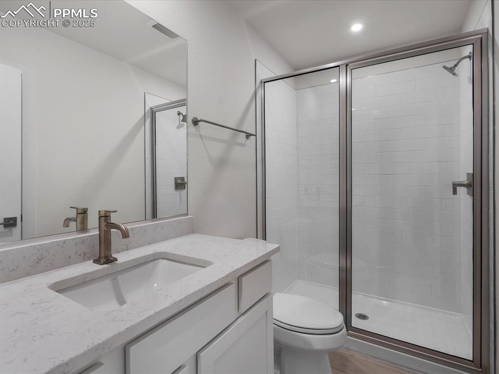 Bathroom with a shower stall and vanity