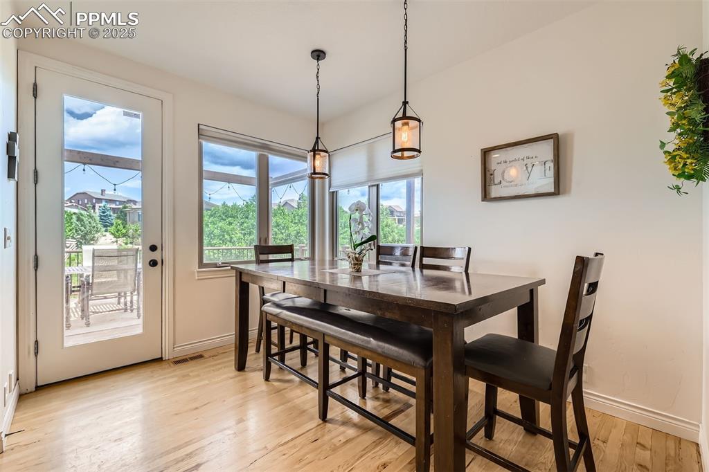Dining space with light hardwood flooring and baseboards
