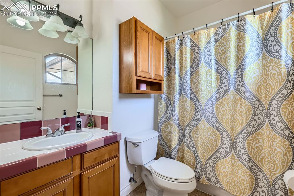 Bathroom featuring vanity and curtained shower