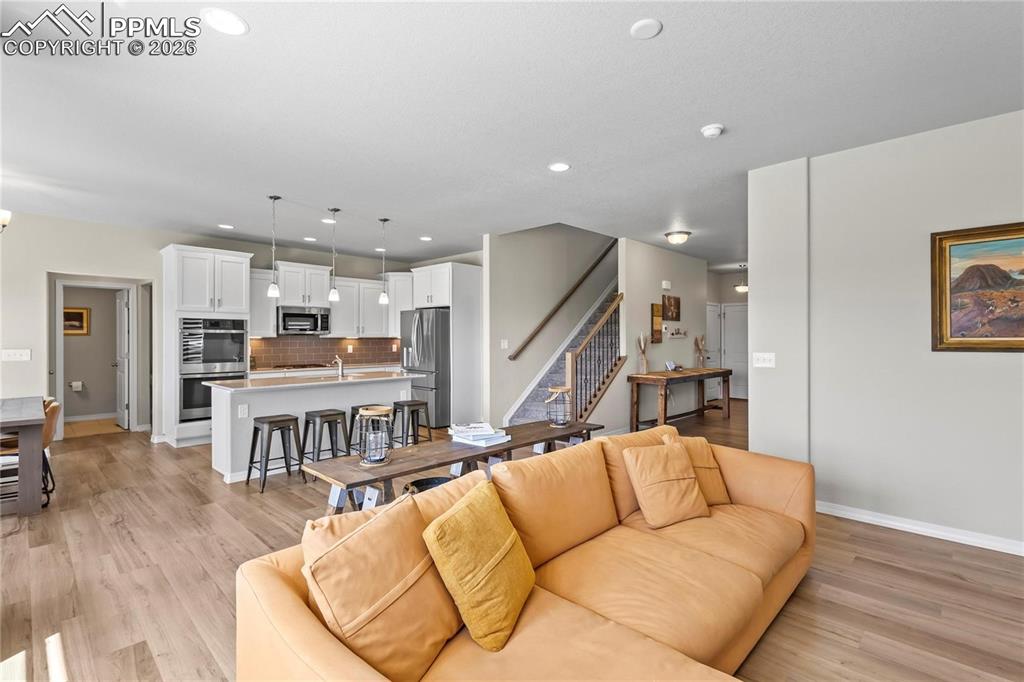 Living room featuring light wood-style flooring and recessed lighting