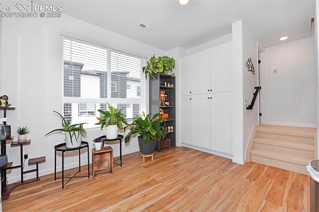 Sitting room featuring light wood-style flooring, stairway, and recessed lighting