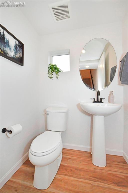 Half bathroom with light wood-style flooring