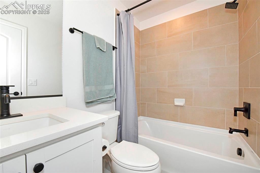 Full bath featuring vanity and shower / tub combo