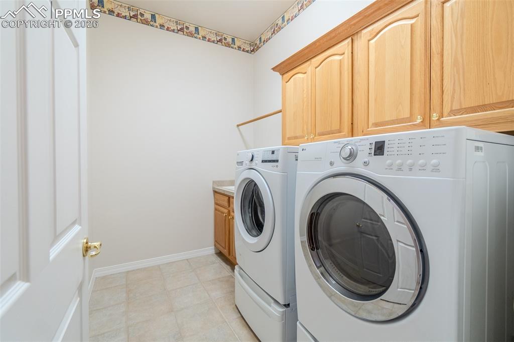 Laundry room on Main level w/ separate washer , dryer, cabinet space and sink! 