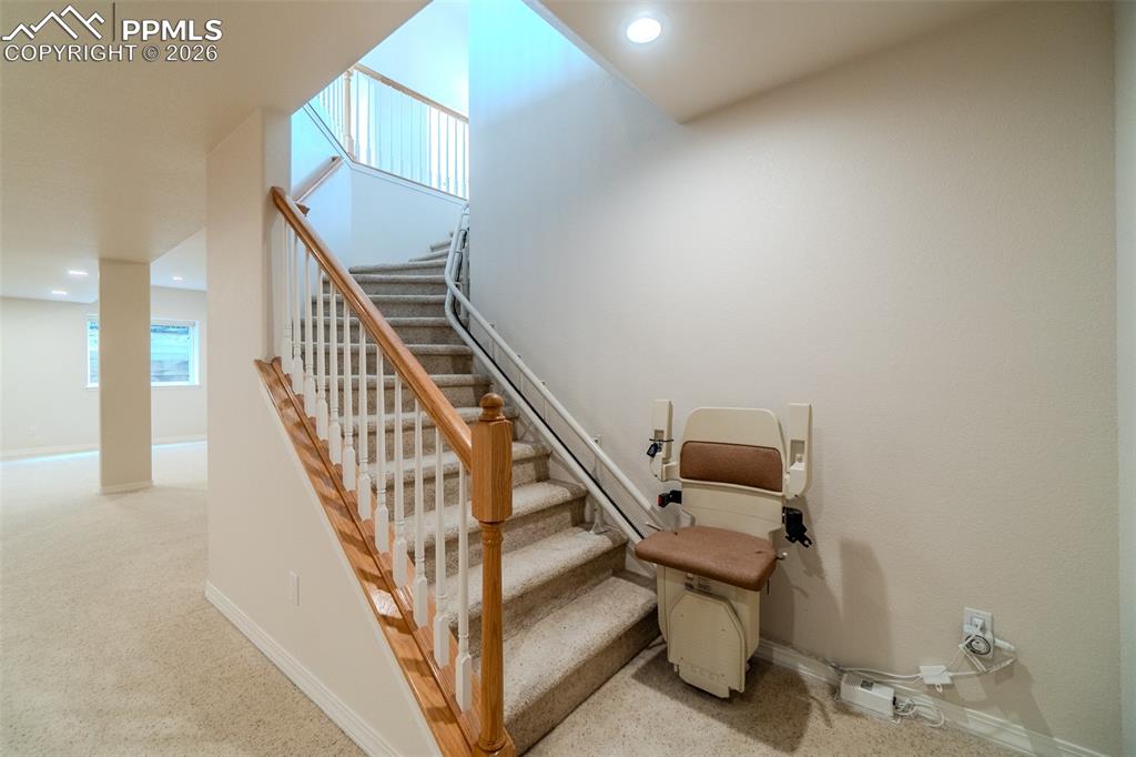 Stairs with carpet flooring and recessed lighting and Shannah brand Electric chair