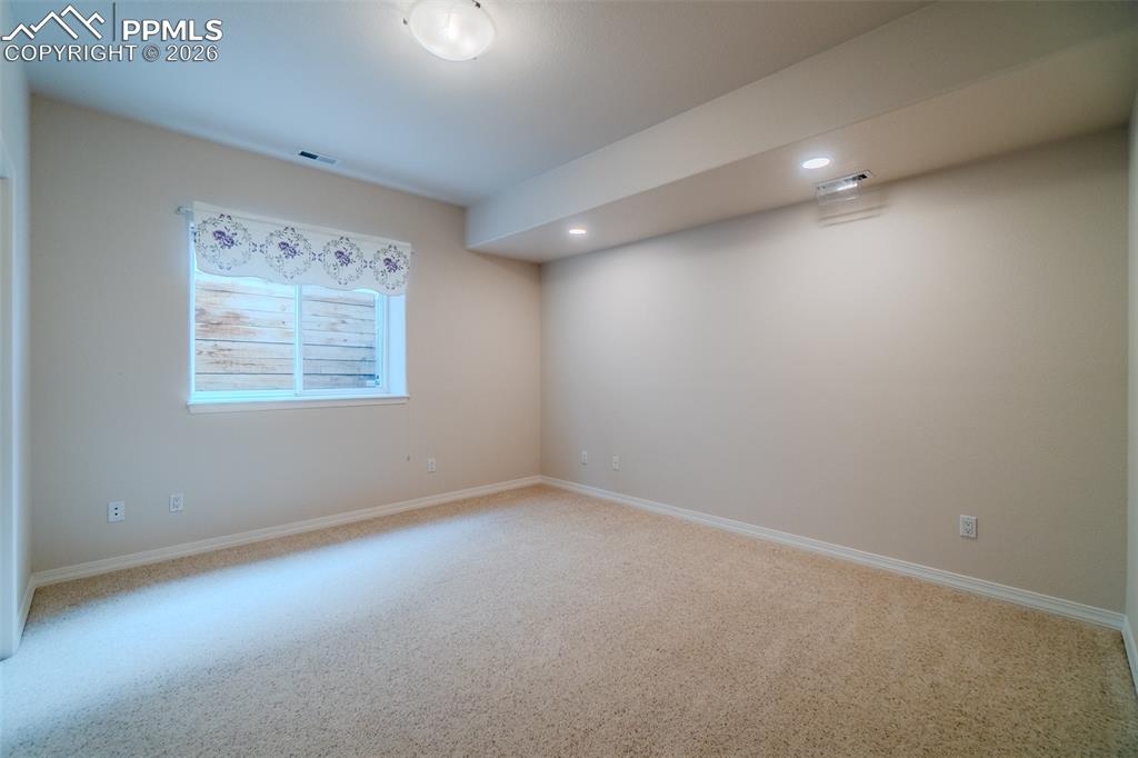 Bedroom in basement carpet and recessed lighting