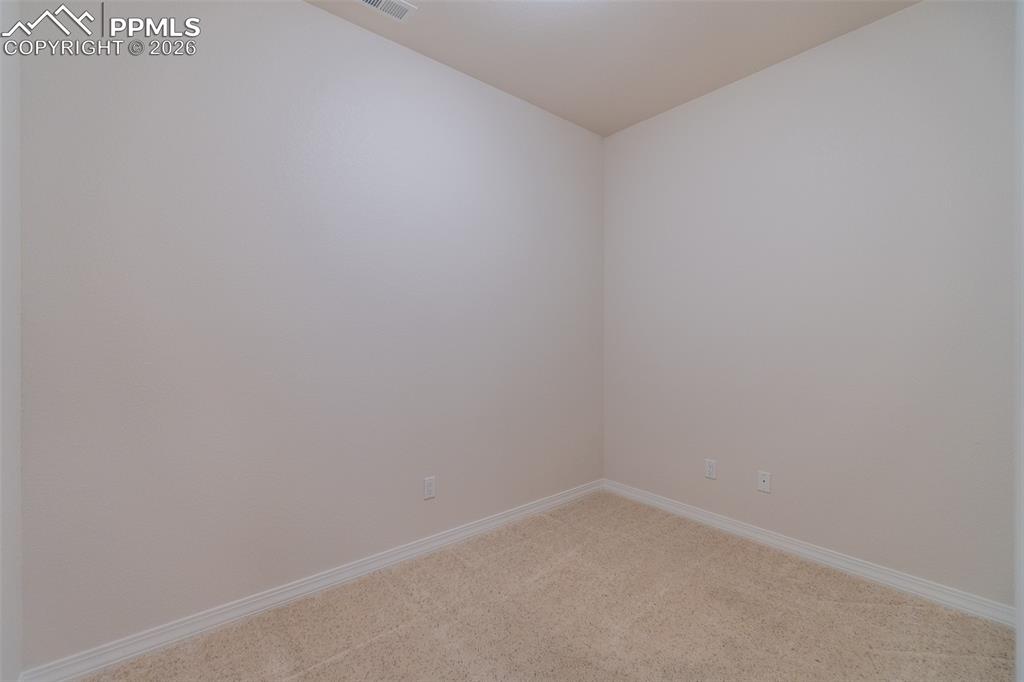 Unfurnished room with carpet floors and baseboards