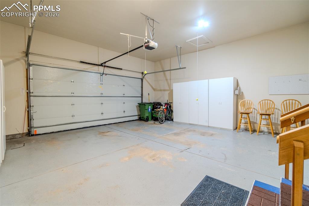 Garage featuring a garage door opener