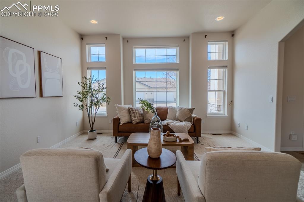 Carpeted living room with recessed lighting
