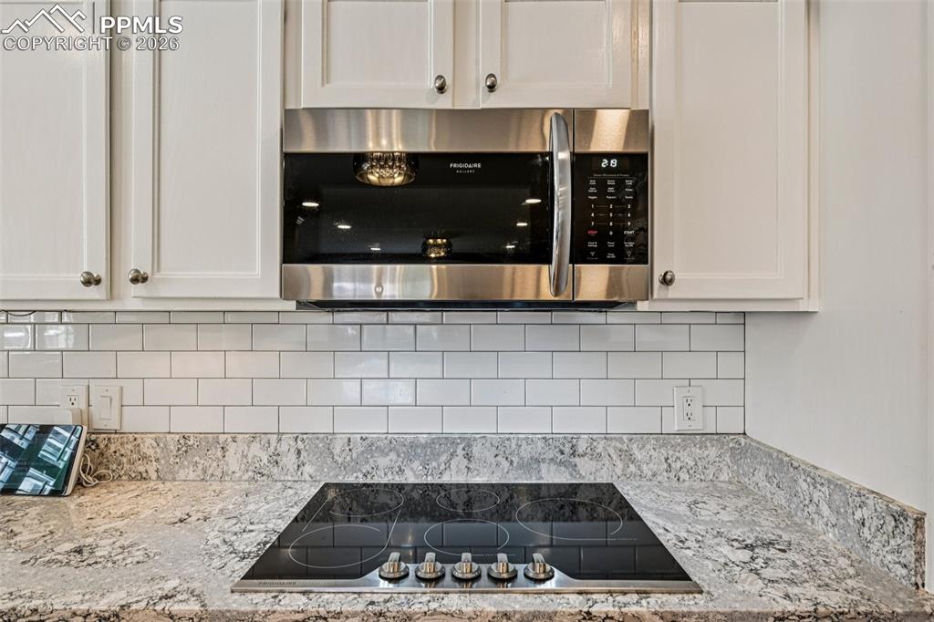 Granite slab counters and tile backsplash