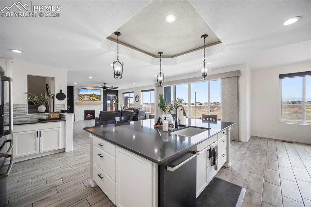 Kitchen with a sink, dark countertops, recessed lighting, and wood tiled floor
