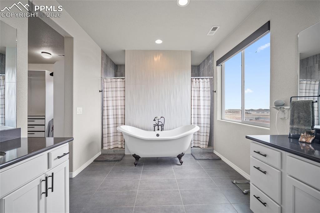 Full bathroom featuring vanity, baseboards, and visible vents