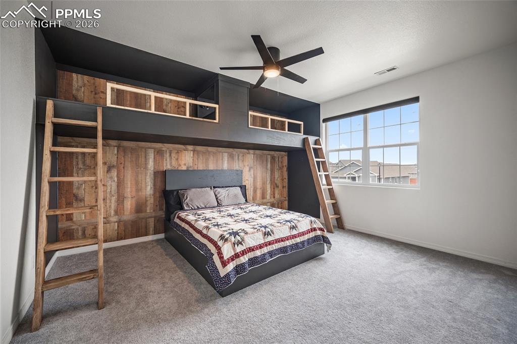 Carpeted bedroom with built in bunk beds