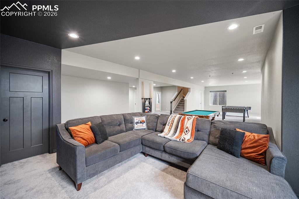 Living area featuring pool table, recessed lighting, stairway, visible vents, and light colored carpet