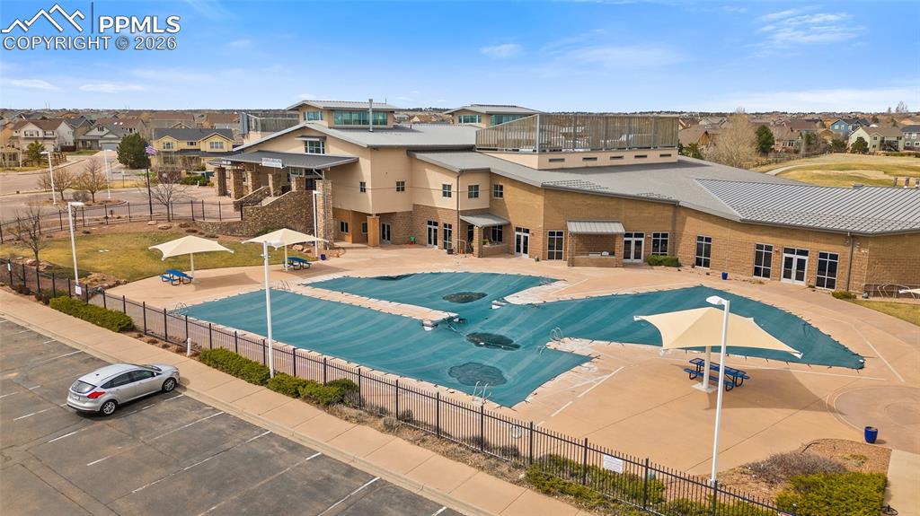 View of pool featuring a residential view, a patio, and fence