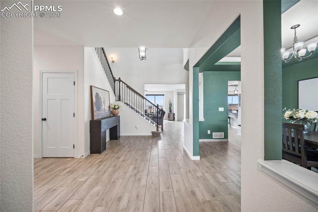 Entrance foyer featuring tall ceilings, formal dining room and office.