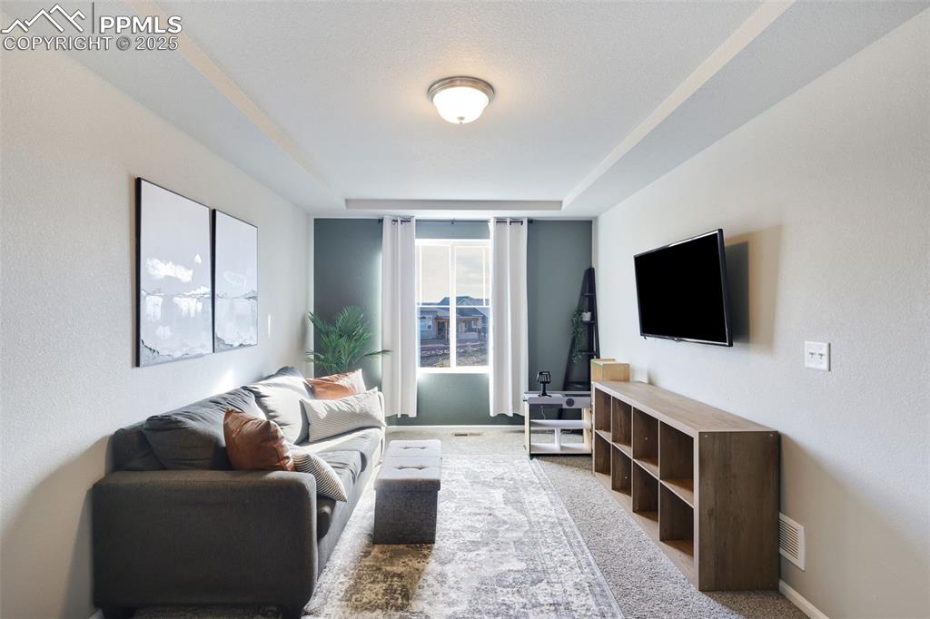 Living room featuring light colored carpet and baseboards