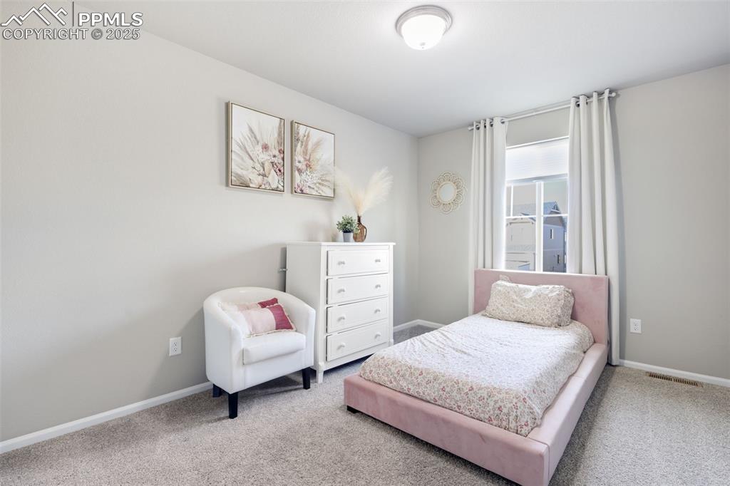 Carpeted bedroom featuring baseboards