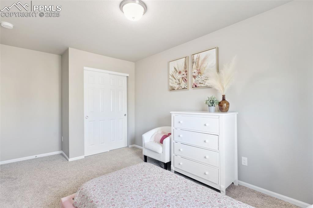 Bedroom featuring carpet floors and baseboards