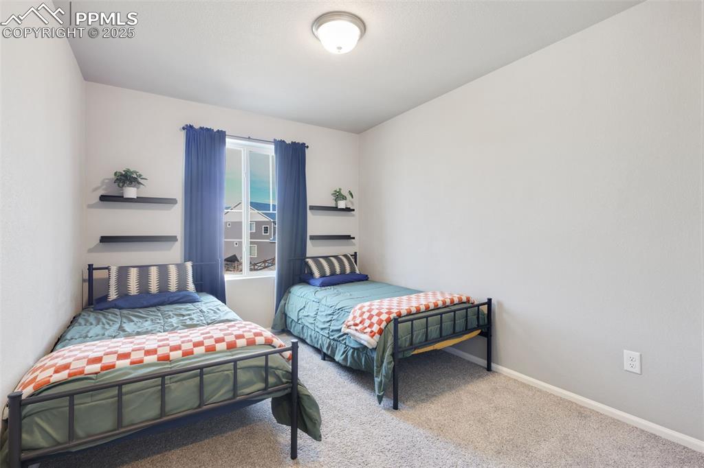 Carpeted bedroom featuring baseboards