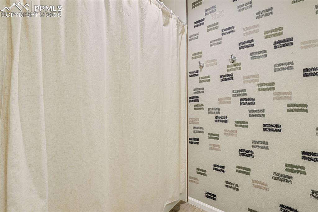 Bathroom featuring curtained shower