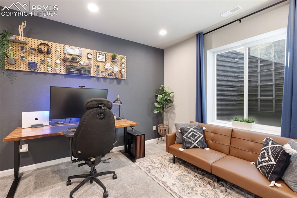 Carpeted office featuring baseboards