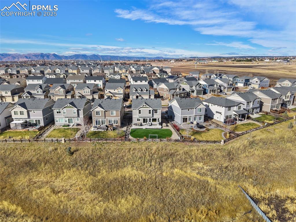 Aerial perspective of suburban area featuring a mountainous background