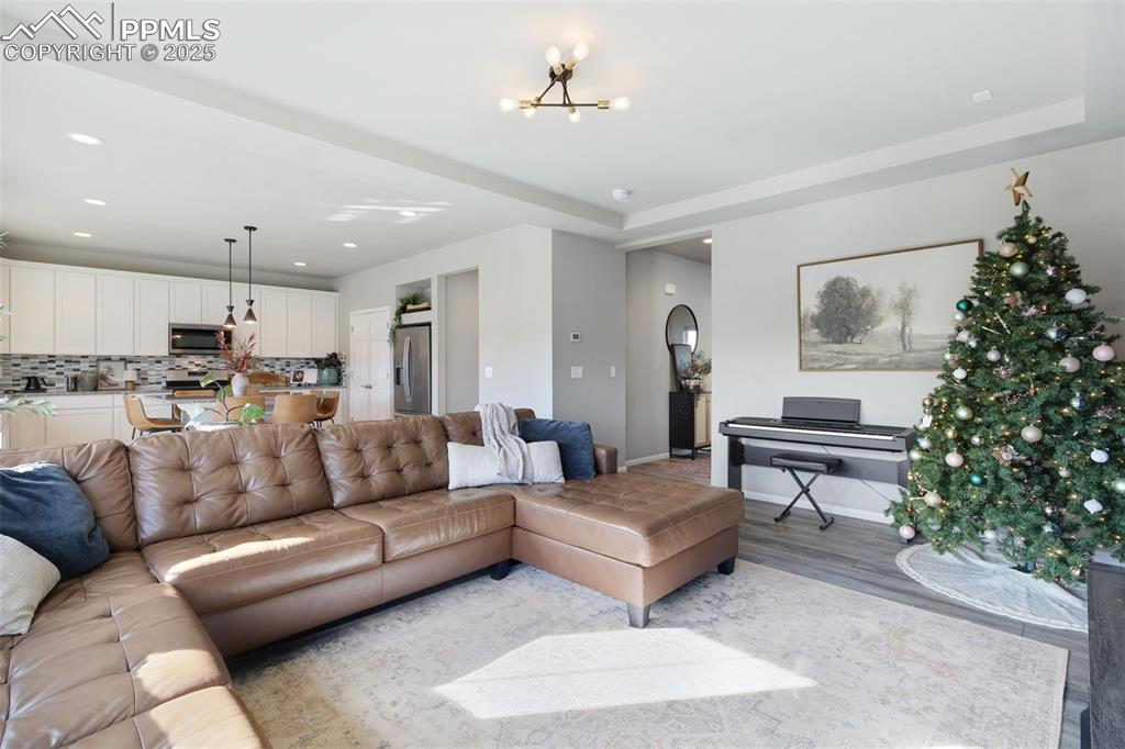 Living room featuring recessed lighting, a chandelier, and wood finished floors