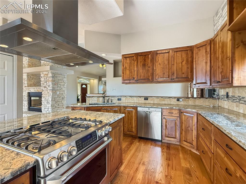 Two way gas fireplace viewed from living room, dining area on the other side