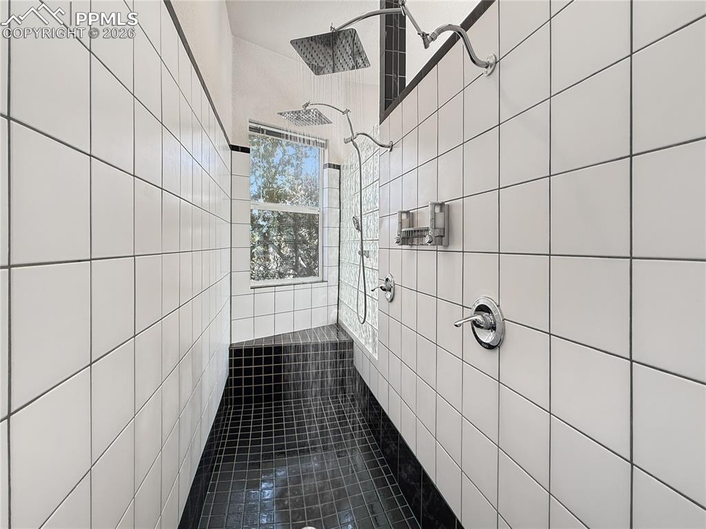 Large bathroom with double vanity and another closet for storage