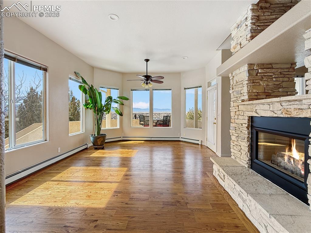 Cozy fieplace and entrance to wide open deck for entertaining or relaxing