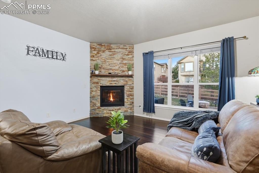 The living room is kept cozy with a corner gas fireplace with a stone surroud. 