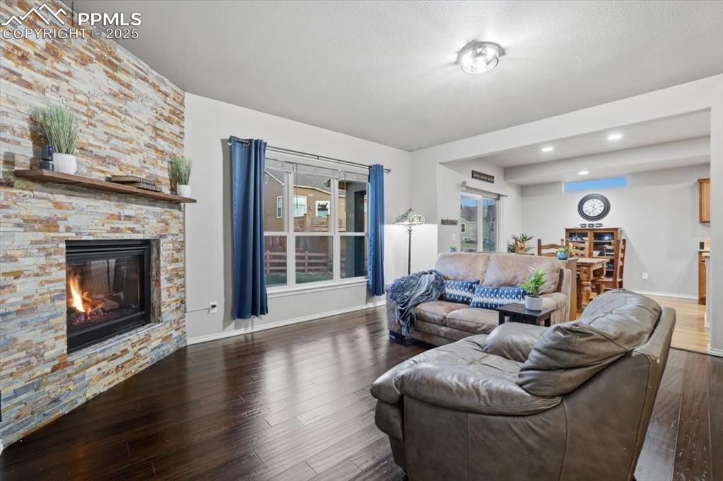 The living room has hardwood floors and great views of the back yard. 