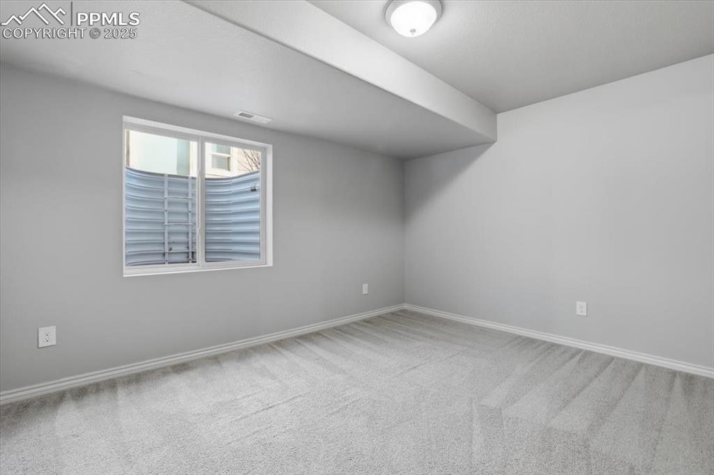 This basement-level bedroom gets lots of light from the double window and also has a double closet. 