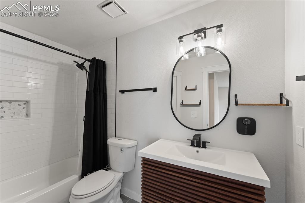 Bathroom with vanity and shower / tub combo