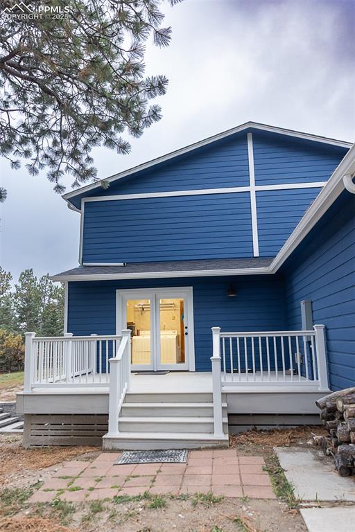 Composite deck on side of home with access to laundry / mud room.