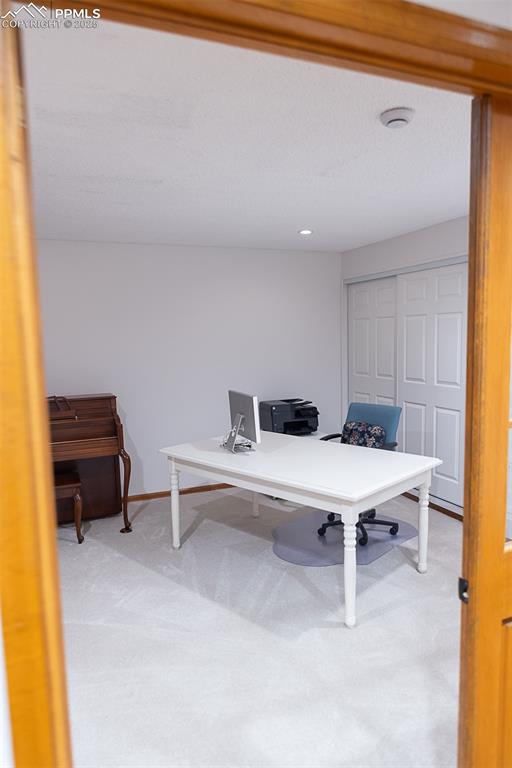 French doors off the foyer lead to a bedroom, currently being used as an office.